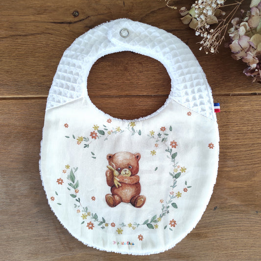 Bavoir ourson fond écru- bretelles pressions nid d'abeille blanc