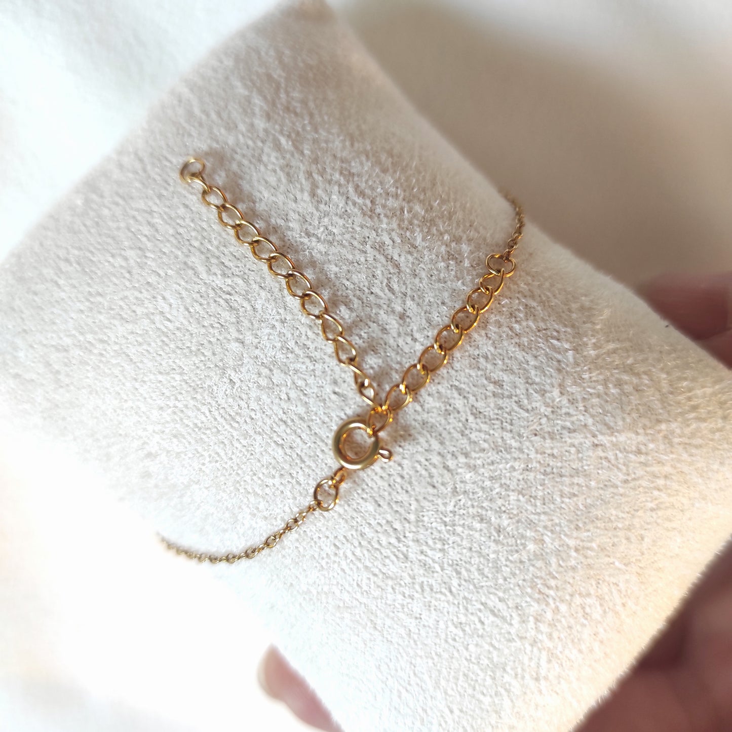 Vue du bracelet de dos, positionné sur un présentoir, la chaîne est couleur dorée.