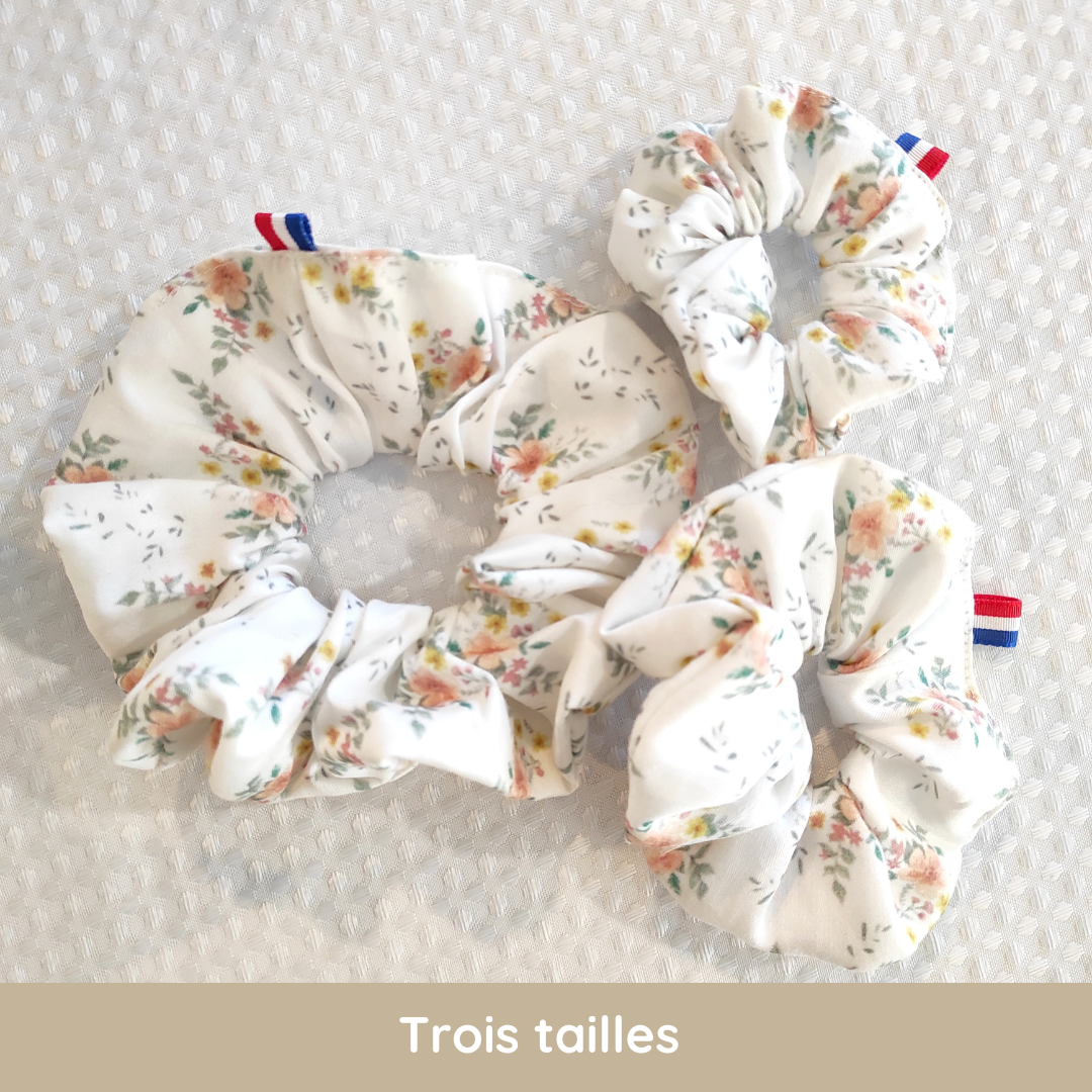 Chouchous au motif fleuri dessiné par Fanny Agustin, 3 tailles possibles. Le motif est orange, jaune et quelques touches de feuilles vertes sur fond blanc.